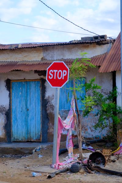 Stop sign in front of a weathered building in Fomboni, Mohéli (Comoros) M'lédjélé, Comoros