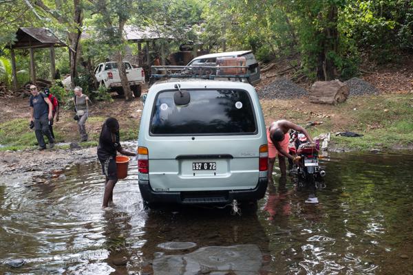 Washing a van and motorcycle at a forest stream crossing, Mohéli (Comoros) Moimbao, Comoros