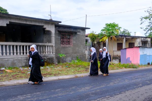 Students in hijabs walking along a street in Moroni, Comoros Moroni, Comoros
