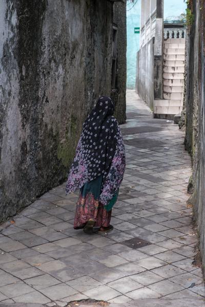 Woman Walking Through a Narrow Alley in Moroni, Comoros Moroni, Comoros