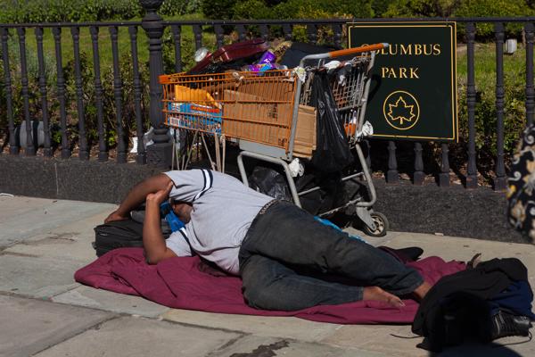 Sleeping on the sidewalk by Columbus Park, Brooklyn New York, United States