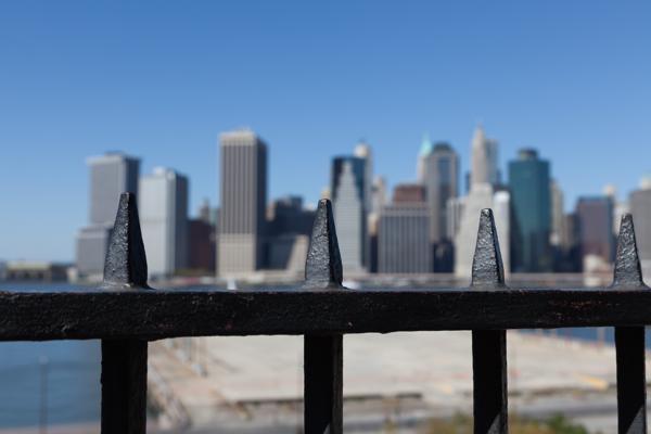 Lower Manhattan skyline behind an iron fence, Brooklyn waterfront New York, United States