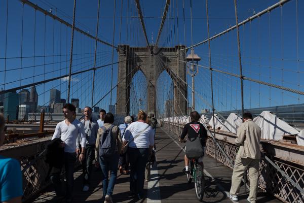 Pedestrians and a cyclist on the Brooklyn Bridge, New York City New York, United States