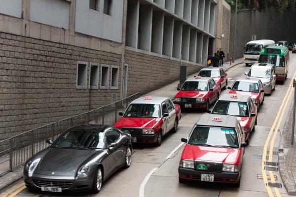 Hong Kong red taxis queuing on a narrow Central District street (Feb 2009) Hong Kong, China