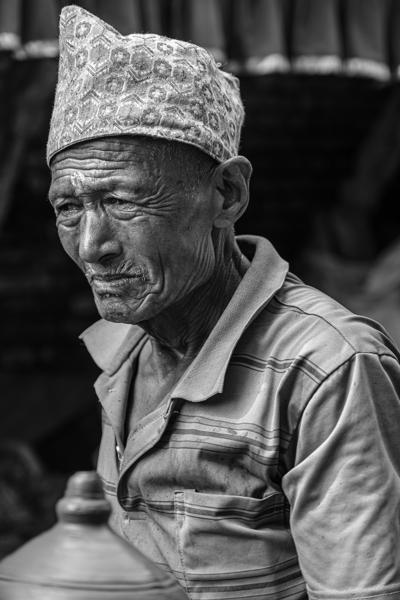 Portrait of a Nepalese Street Vendor in a Striped Shirt and Dakka Cap Bhaktapur, Nepal