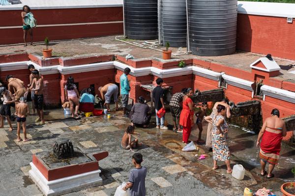 People washing clothes at a temple courtyard Lalitpur, Nepal
