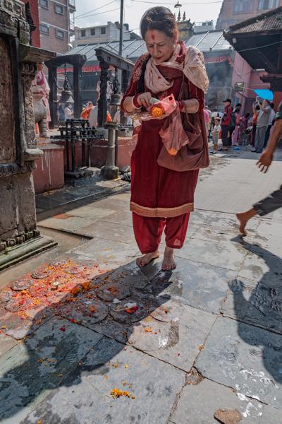 Barefoot woman performing a temple ritual in Nepal Lalitpur, Nepal
