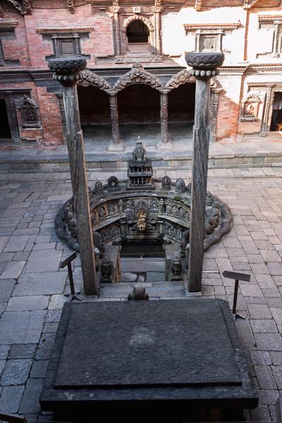 Intricately Carved Circular Well in a Nepalese Brick Courtyard Lalitpur, Nepal
