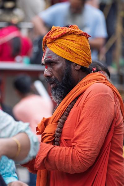 Sage in orange robes at a bustling market Kathmandu Metropolitan, Nepal