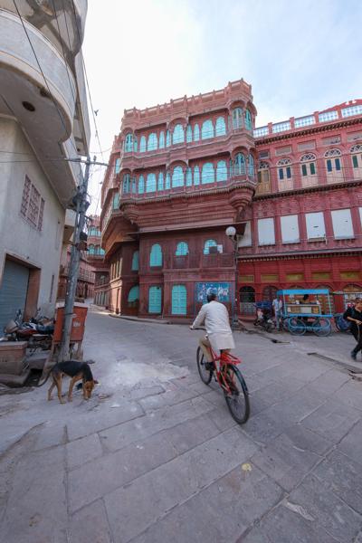 Cyclist Passing a Red-Sandstone Haveli in Old Bikaner, Rajasthan Bikaner, India