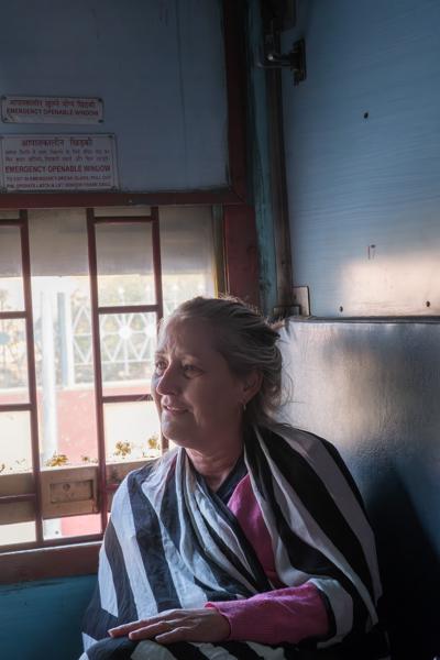 Passenger by an Emergency Window on an Indian Train, Rajasthan Kolayat, India