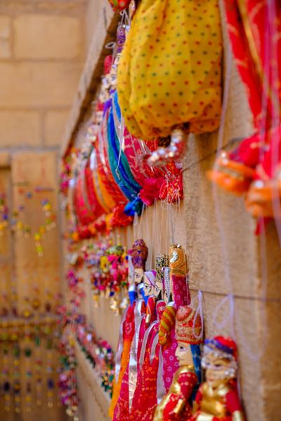 Colorful Rajasthani Kathputli Puppets Hanging on a Sandstone Wall, Jaisalmer Jaisalmer, India