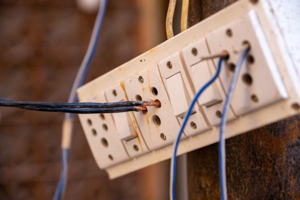Unsafe outdoor electrical socket panel with exposed wiring Jaisalmer, India