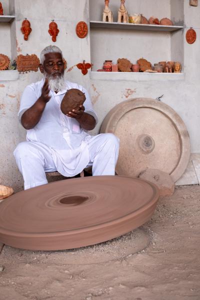 Potter Shaping Clay on a Spinning Wheel in Jodhpur, Rajasthan Kakani, India