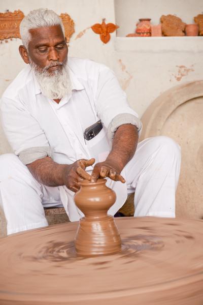 Potter Shaping a Clay Vessel on a Spinning Wheel, Jodhpur (Rajasthan) Kakani, India