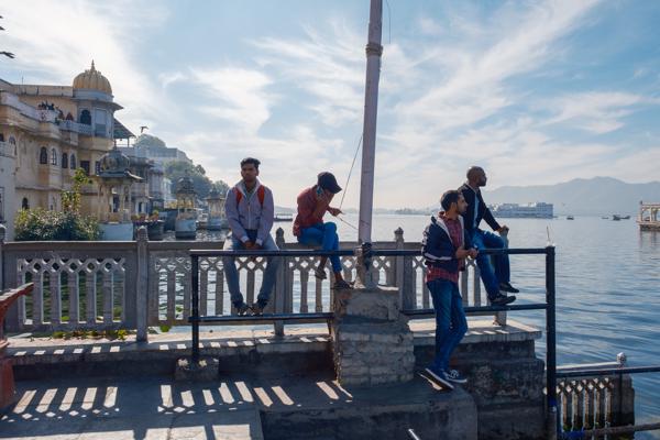 Men relaxing on Lake Pichola waterfront in Udaipur, India Udaipur, India