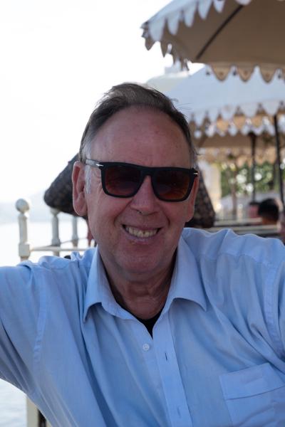 Smiling Man in Sunglasses at a Lakeside Café in Udaipur Udaipur, India