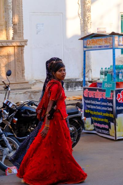 Woman in Red Traditional Dress Passing a Street Soda Stall, Pushkar (Rajasthan) Pushkar, India