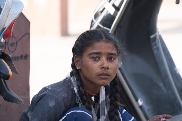 Portrait of a Young Woman Beside Parked Scooters in Rajasthan, India Pushkar, India