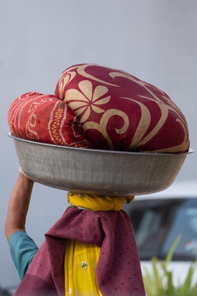 Woman Carrying Bedding in a Metal Basin, Pushkar (Rajasthan) Pushkar, India