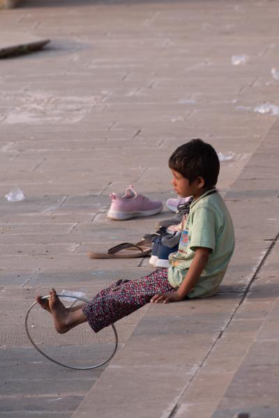 Child Sitting on Stone Ghat Steps in Pushkar, Rajasthan Pushkar, India