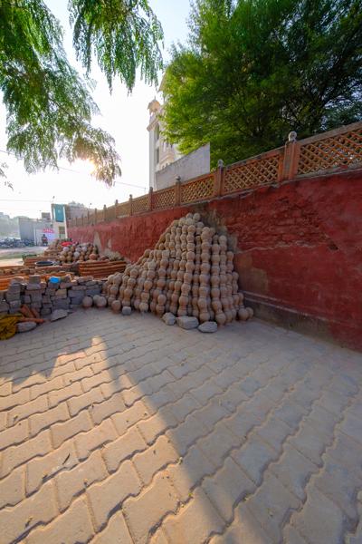 Stacks of terracotta pots by a red wall in Jaipur, India Jaipur, India