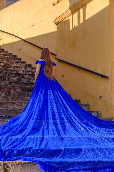 Woman in a flowing blue gown on the stairs at Amber Fort, Jaipur Jaipur Municipal Corporation, India