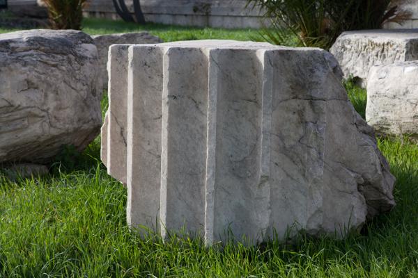 Fluted stone blocks in a grassy park setting Athens, Greece