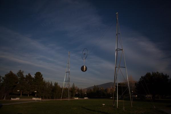 Kinetic steel sculpture over a park lawn in Athens Athens, Greece