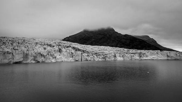 Glacial Edge and Cloud-Crowned Mountain ( Iceland ) Iceland