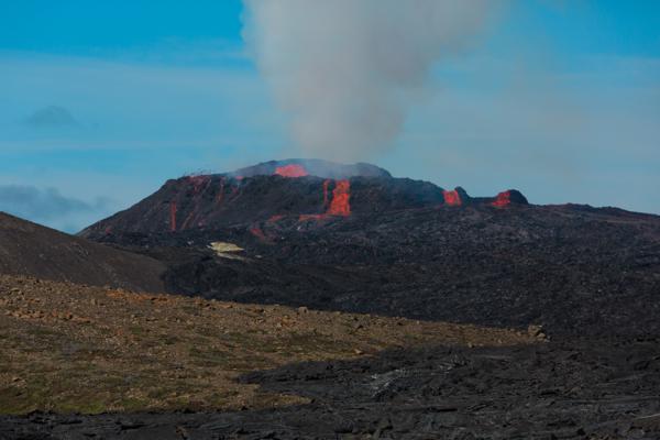 Glowing lava and steam from a volcanic crater Iceland