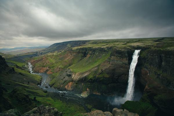 Icelandic Canyon with a Dramatic Waterfall under Moody Skies Iceland