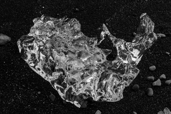 Crystal shard on Icelandic black sand Iceland