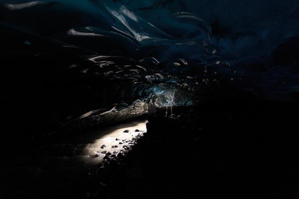 Blue Ice Cave Interior with Sunlit Ground Iceland