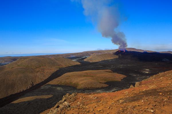 Volcanic crater plume over a rugged lava field Iceland