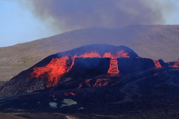 Glowing Lava Flows Across a Dark Volcanic Landscape Iceland