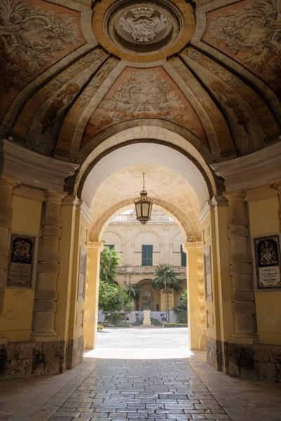 Sunlit Archway into a Historic Valletta Courtyard Valletta, Malta