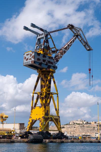 Camouflaged Yellow Port Crane at Grand Harbour, Malta Port Region, Malta