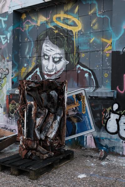 Rusty sculptural installation in front of a graffiti mural Bezirk Lebern, Switzerland