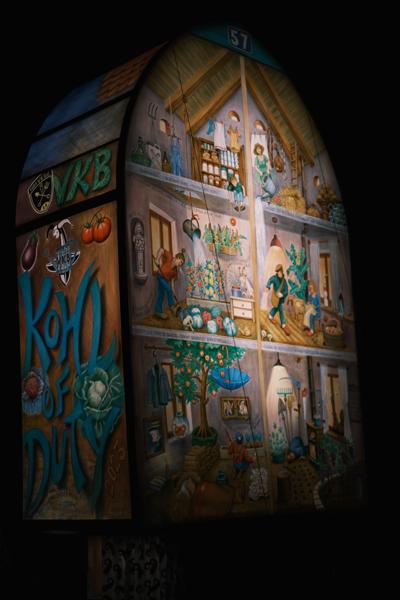 Night-time mural inside a multi-panel wooden house Basel, Switzerland