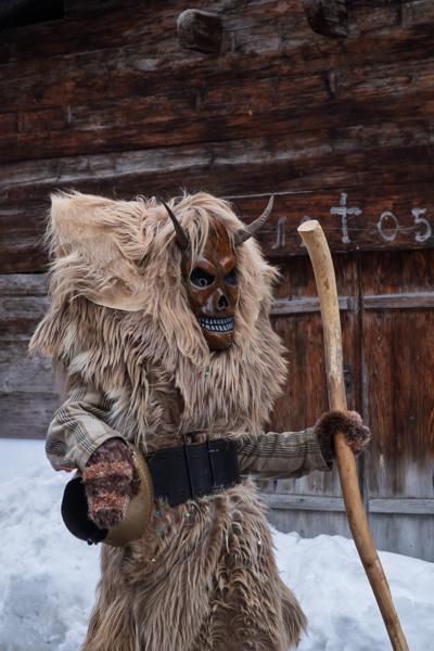 Tschäggättä Carnival Figure in Snowy Swiss Alpine Village Wiler (Lötschen), Switzerland