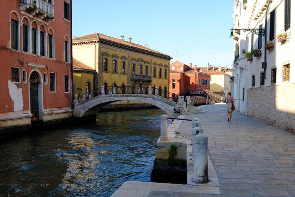 Colorful canal street in Venice with pedestrian bridge Venice, Italy